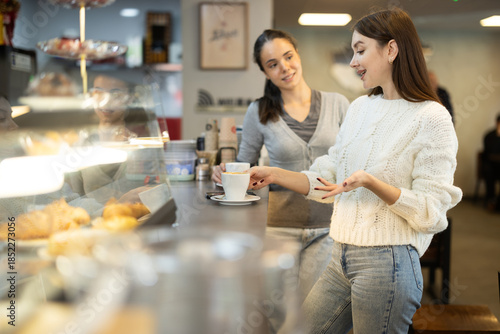 Two women talking over cup of coffee in a cafe