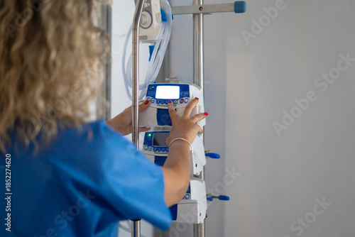 Canvastavla Nurse adjusting medical infusion pump in hospital setting