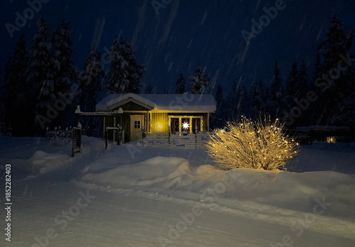 A small house decorated with Christmas lights on a snowy cold night