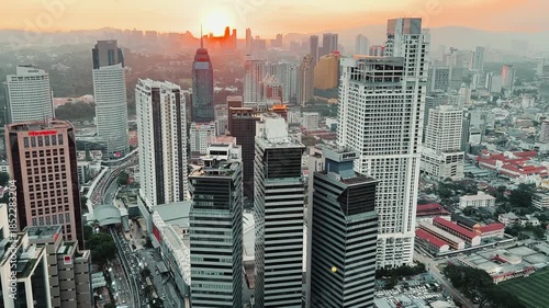 Kuala Lumpur, Malaysia, June 8, 2025: Sunset from an observation deck in Kuala Lumpur. Sunset sky illuminated by twilight, TV tower, and high-rise buildings from the air in the city center. 4K