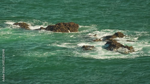 Powerful Ocean Waves Crashing Over Rugged Rocks