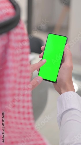 Arab Man Using Phone with Green Screen, vertical video