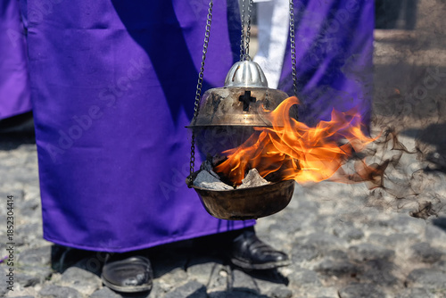 Tableau sur toile Burning incense in a metal censer carried during Holy Week procession in Antigua, Guatemala