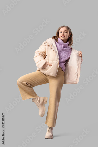 Stylish young woman in beig...