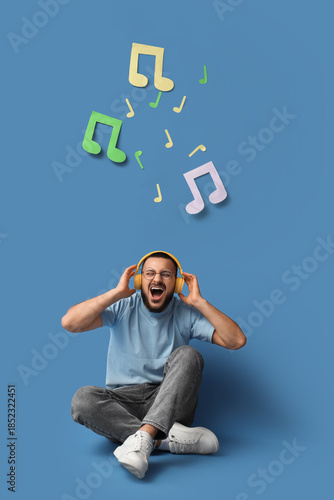 Young man in headphones wit...