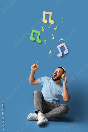 Singing young man in headph...