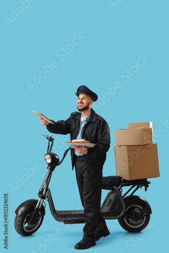 Handsome postman with lette...
