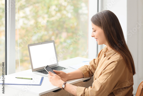 Young businesswoman using m...