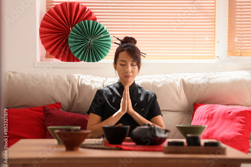 Young Asian woman meditatin...