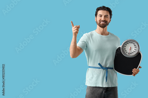 Young man with weight scale...