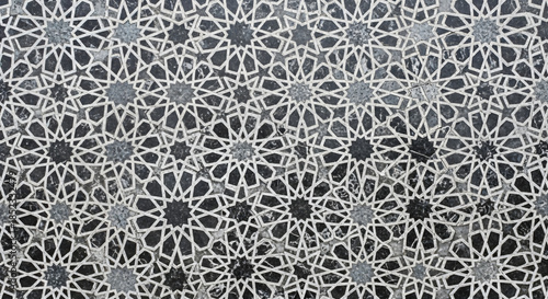 Intricate Islamic geometric star patterns on grey stone surface