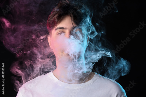 Handsome young man smoking ...