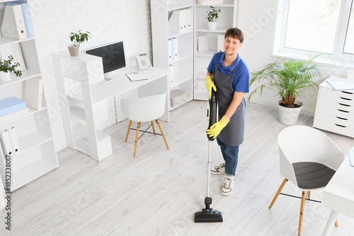 Young male janitor with mod...
