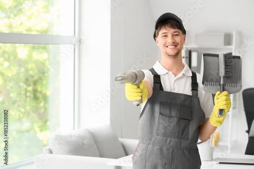 Young male janitor with mod...