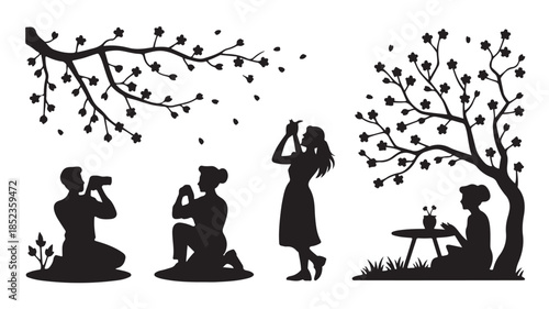 Couple taking photos in romantic silhouette with blooming tree in soft black and white for wedding decor
