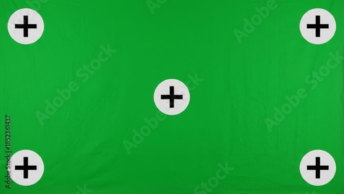 Green screen background with tracking markers for digital compositing