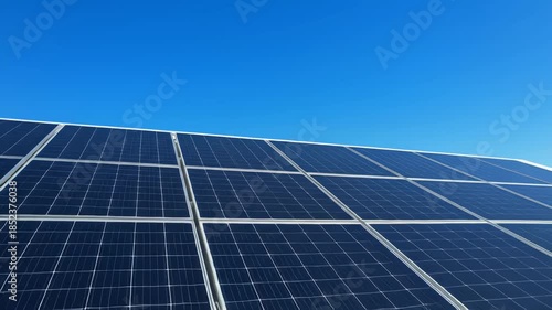 Modern residential house with rooftop solar panels under a clear blue sky. Clean architectural video showcasing future-ready sustainable energy under bright daylight in 4K