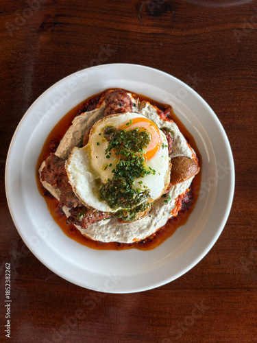 Breakfast plate of sausage egg with hummus.