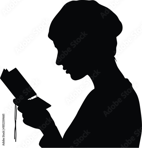 Silhouette of a young person reading a book