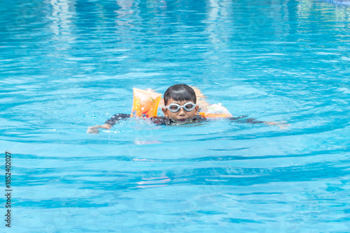 Boy wearing a life jacket in the pool