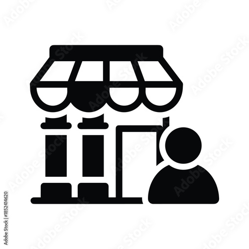 Person standing outside storefront with awning