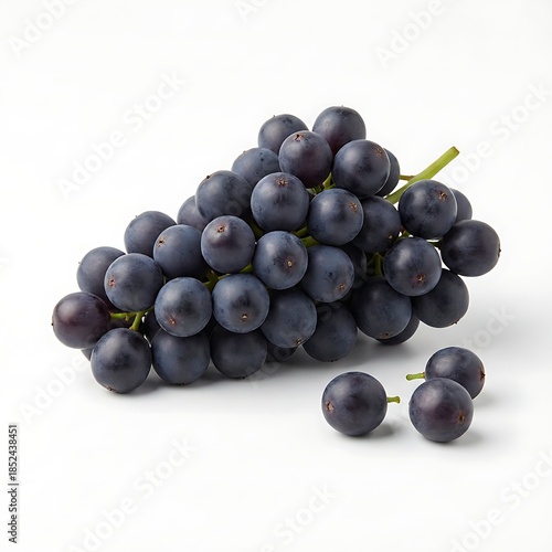 A close-up shot of a cluster of dark purple grapes with green stems on a white background, with a few loose grapes in front.
