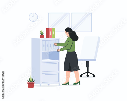 A woman in a green dress is looking for documents in an office filing cabinet.