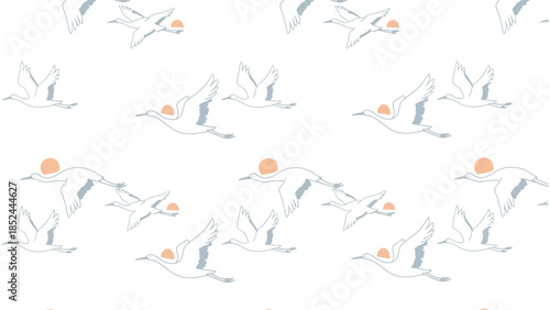 Graceful white cranes in flight against a soft pastel sky with sun.