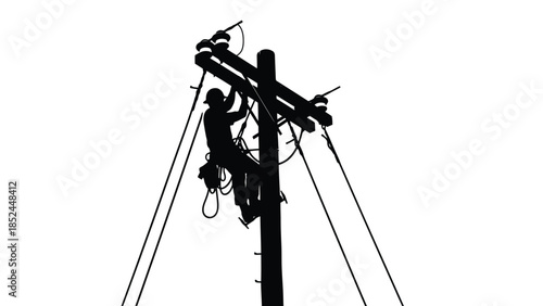 Silhouette of a lineman working on a utility power pole high up