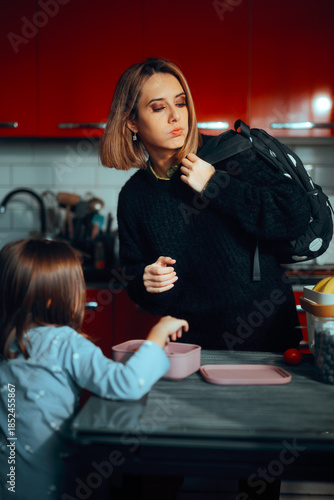 Фотография Tired Mom Gets Her Child Ready for School