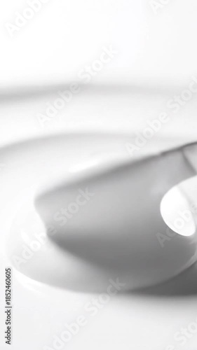 A macro shot featuring swirled white substance, creating a smooth, abstract pattern