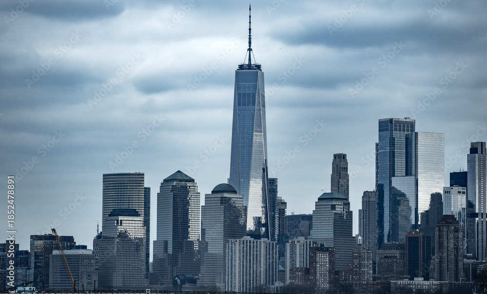 Fototapeta premium New York City skyline wide banner. Manhattan skyline with glass towers. NYC skyline landscape. New York panorama city. Manhattan skyline glowing at dusk. NYC with downtown towers.