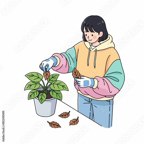 Young woman caring for her indoor plant by removing dry leaves, enjoying her peaceful gardening hobby