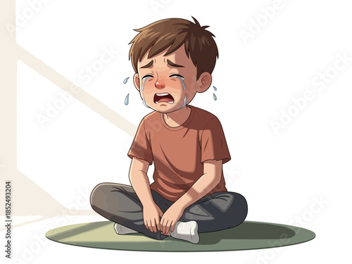 Crying boy sitting on the floor with tears on his face