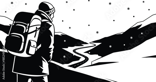 Hiker with backpack standing on snowy mountain road in winter