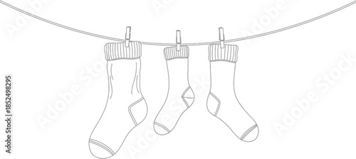 Three socks hanging on a clothesline with clips, black and white line art illustration, laundry day concept