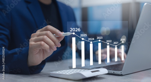close up manager businessman write and think strategy of business profit with virtual statistic graph for new year 2026 target and financial forecasting in office room concept