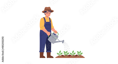 Male farmer in hat and overalls watering young plants in a garden bed.