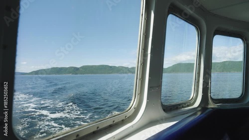 View of Saguenay Fjord from boat window, calm and serene, Quebec, Canada