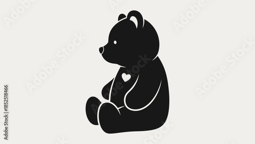 Cute black teddy bear illustration with a small heart on its chest, sitting sideways on a light background.