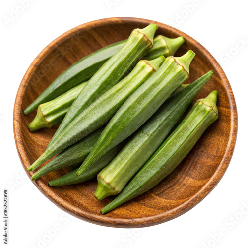 Okra pods arranged in a wooden bowl on a white background, showcasing their vibrant green color and ribbed texture.