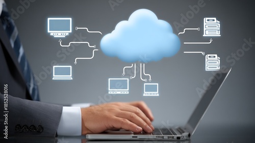 Executive hand touches laptop while cloud computing diagram connects.