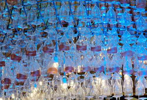 Ceiling decoration, Wine glass hang with structure and blue color lighting decorate ceiling at mall