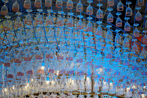 Ceiling decoration, Wine glass hang with structure and blue color lighting decorate ceiling at mall