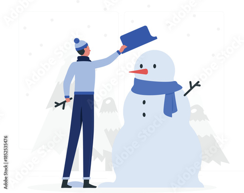 Man in blue clothes putting hat on snowman winter d