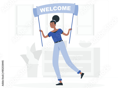 Woman holding welcome banner in blue shirt and light blue jeans de
