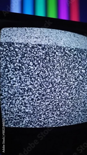 Static screen of an old TV with color bars in the background