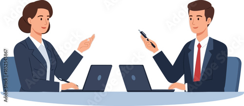 Two professionals in business attire collaborating at a table with laptops.