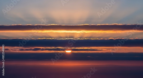 Dramatic Sunset Over Ocean With Sun Rays Breaking Through Clouds.