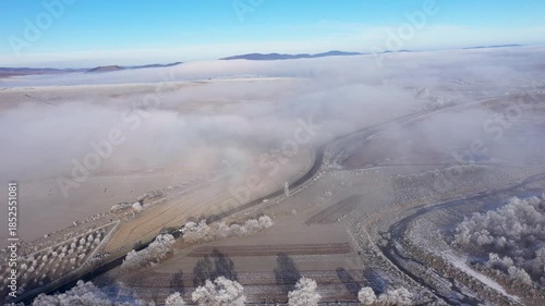Cars passing in misty winter countryside road aerial view